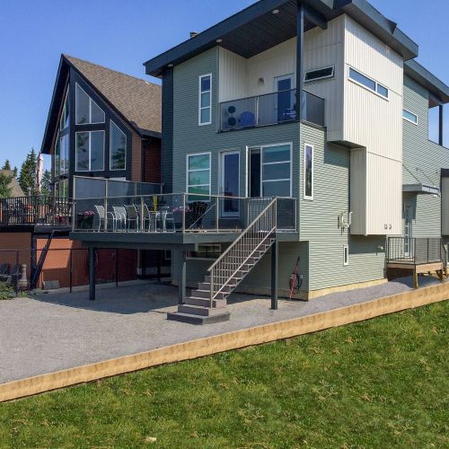 House with glass & aluminum deck railing matched with picket stair railing