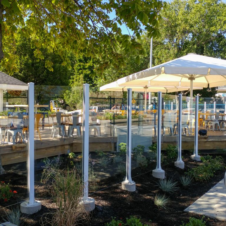 Topless aluminum & glass rail on concrete mount by DekSmart railings manufacturer