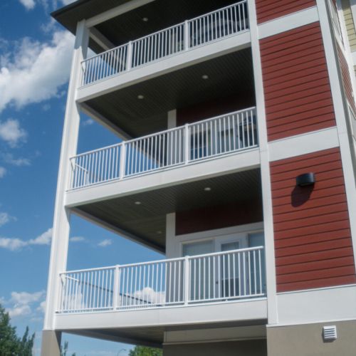 Aluminum picket railing system installed in a multi-family residential building with white top and bottom rail