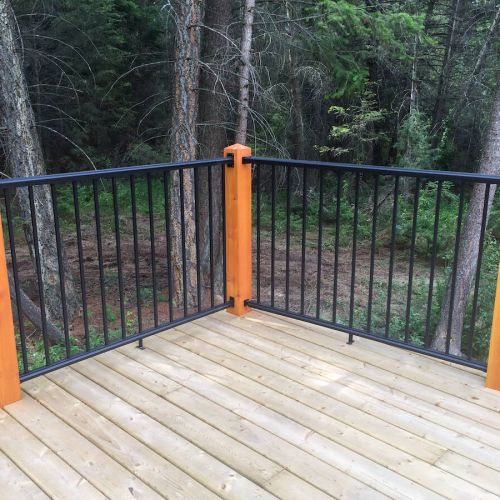 Black picket railing with wood posts