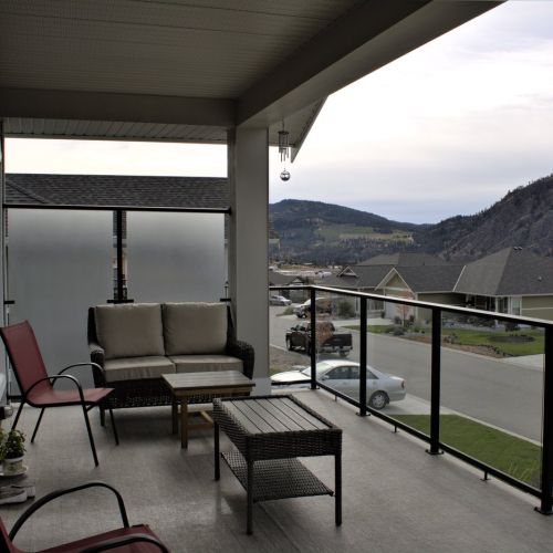 Glass Railing and Privacy Wall with black aluminum bars and surface mount design