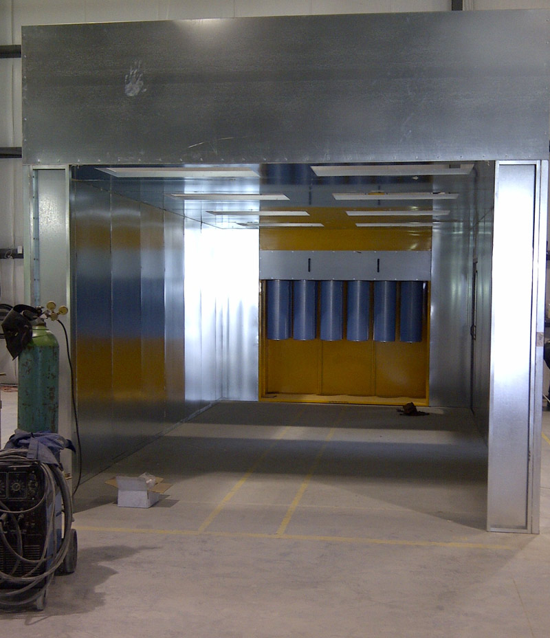 A large metal box used as the powder coating booth area where DekSmart powder coats their products. 