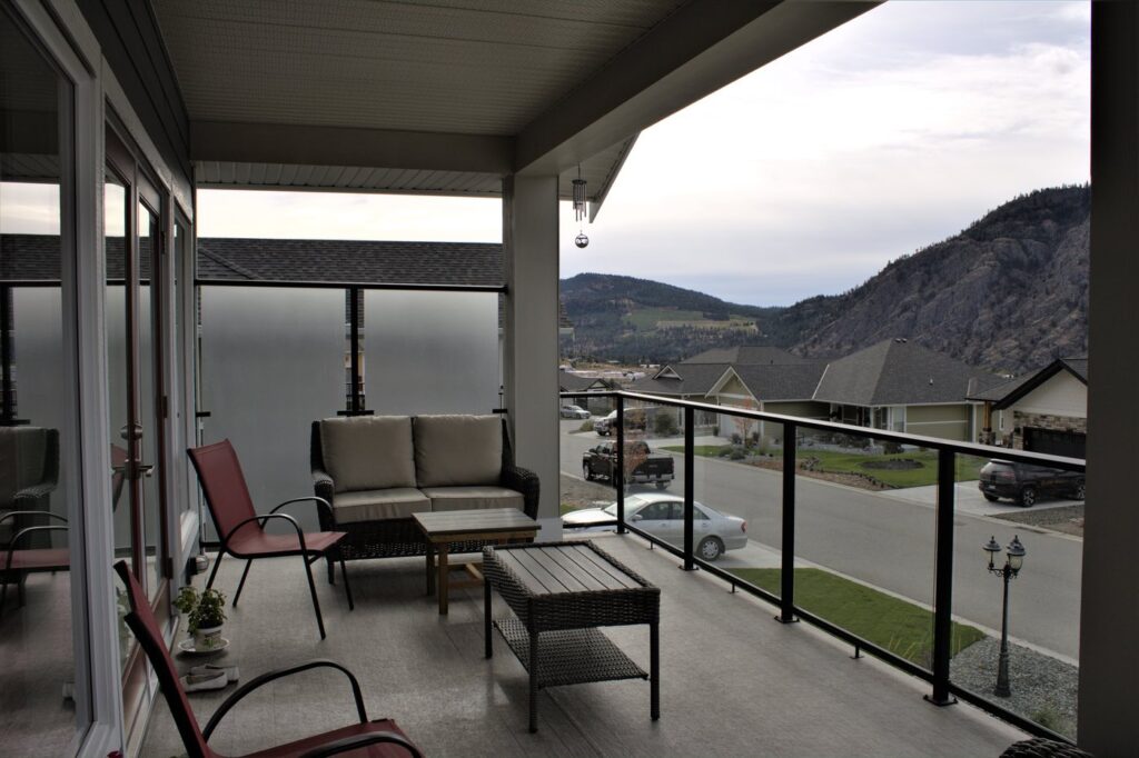 Glass Railing and Privacy Wall with black aluminum bars and surface mount design